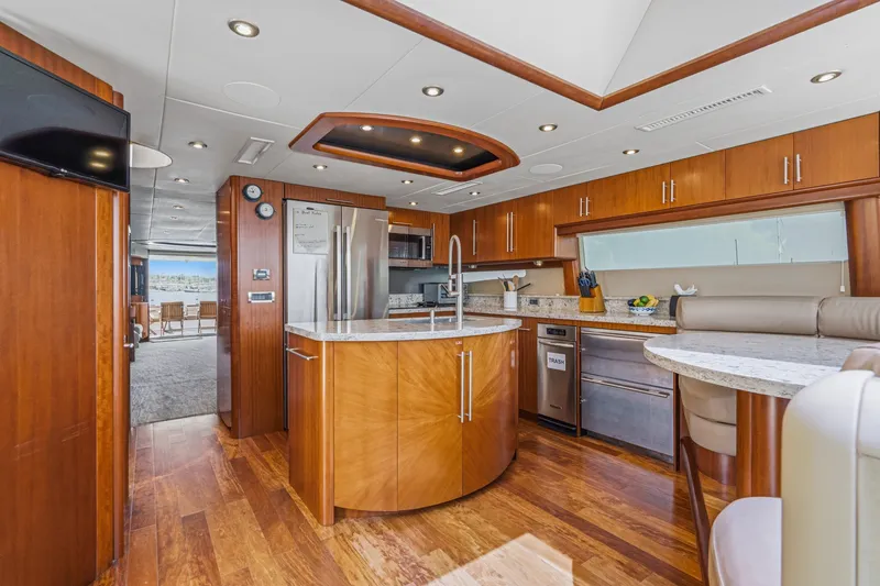 Slide: The Image of Luxurious 2006 Lazzara 84 Flybridge yacht interior with modern kitchen and elegant wood finishes. - 52