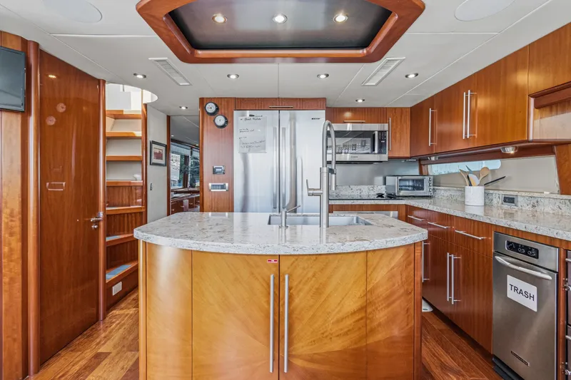 Slide: The Image of Luxurious 2006 Lazzara 84 Flybridge yacht kitchen with modern appliances and elegant wood finishes. - 49