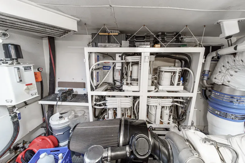 Slide: The Image of Engine room of 2006 Lazzara 84 Flybridge yacht with mechanical equipment and piping. - 102