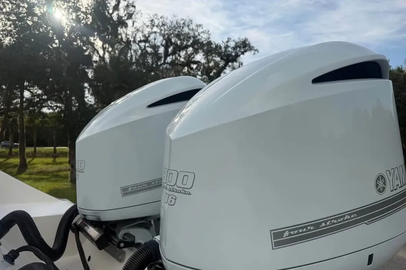 Slide: The Image of Twin Yamaha outboard engines on a 2020 Cobia 301 Center Console boat. - 17