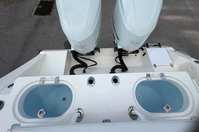 Slide: The Image of 2020 Cobia 301 Center Console with dual outboard engines and live wells. - 14