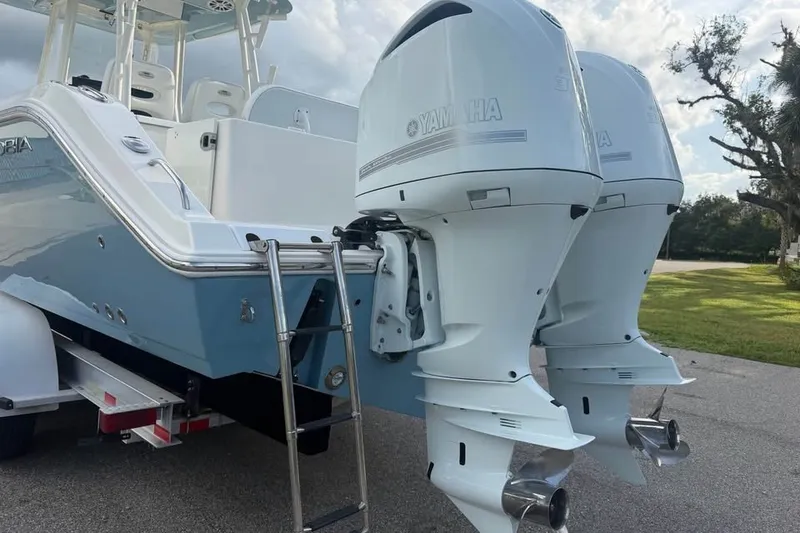 Slide: The Image of 2020 Cobia 301 Center Console boat with twin Yamaha outboard engines. - 15