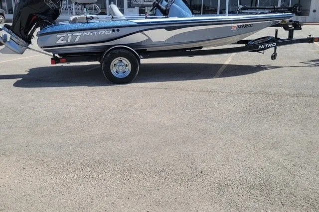 The Image of 2023 Nitro Z17 boat on trailer in parking lot, side view. - 0