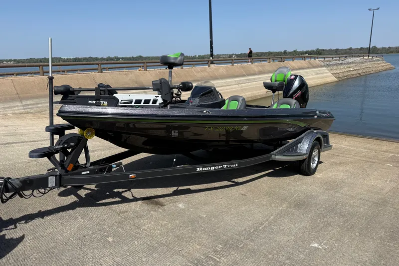 The Image of 2020 Ranger Z518 boat on trailer by a lakeside ramp. - 0