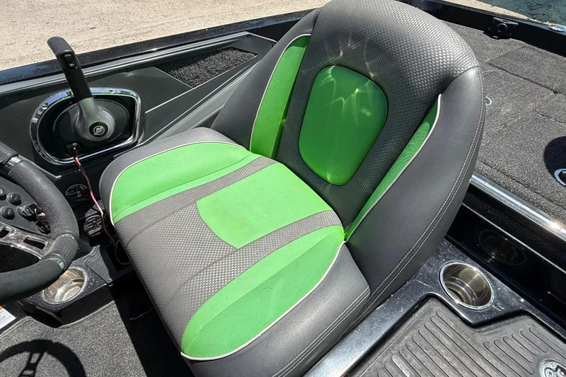 Slide: The Image of 2020 Ranger Z518 boat seat with green and gray upholstery, steering wheel, and control panel. - 47