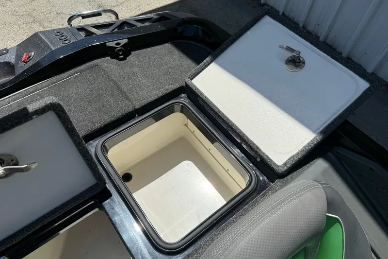Slide: The Image of 2020 Ranger Z518 boat storage compartments with open lids, showcasing interior space. - 51