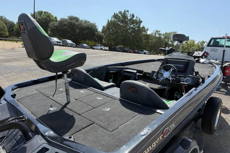 Slide: The Image of 2020 Ranger Z518 fishing boat with seating and steering console in a parking lot. - 19