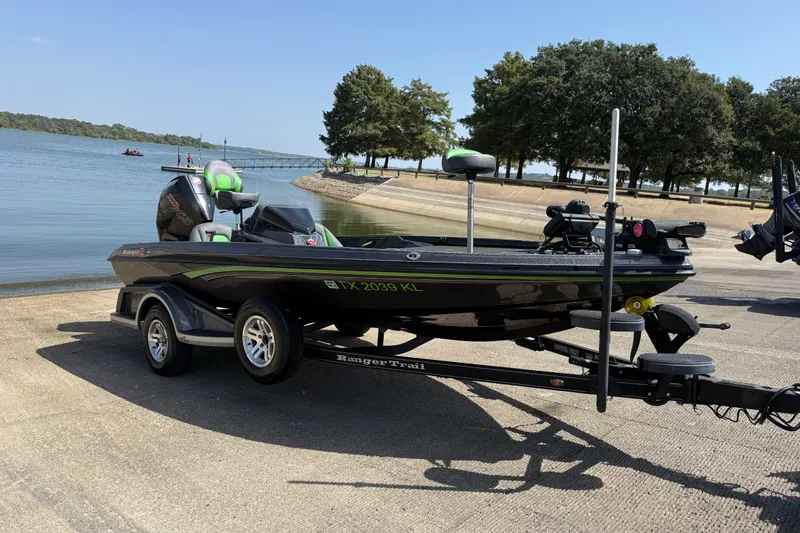 Slide: The Image of 2020 Ranger Z518 boat on trailer by a lake, ready for launch. - 13