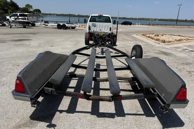 Slide: The Image of 2020 Ranger Z518 boat trailer parked near a lake with a truck. - 56
