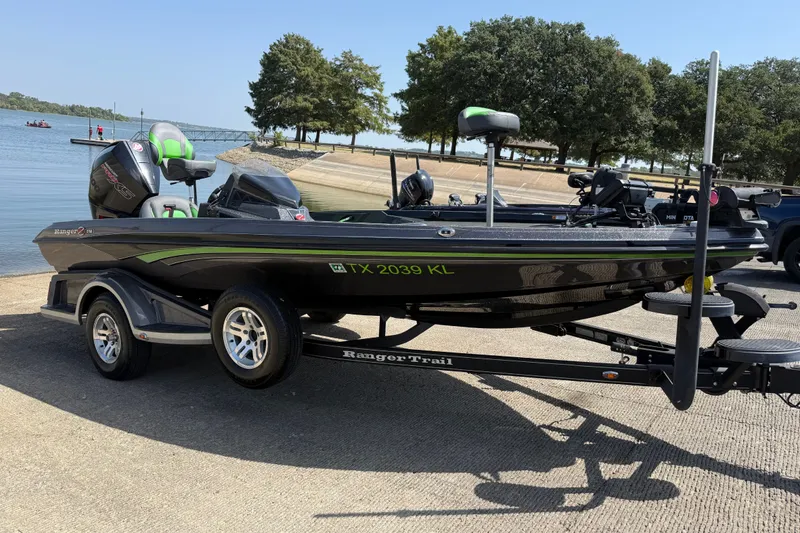 Slide: The Image of 2020 Ranger Z518 boat on trailer by a lakeside ramp, ready for launch. - 16