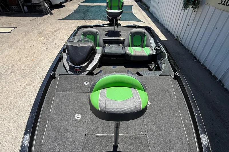 Slide: The Image of 2020 Ranger Z518 boat with green and gray seating, parked outdoors. - 45