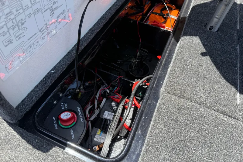 Slide: The Image of 2020 Ranger Z518 boat battery compartment with wiring and switch panel. - 53