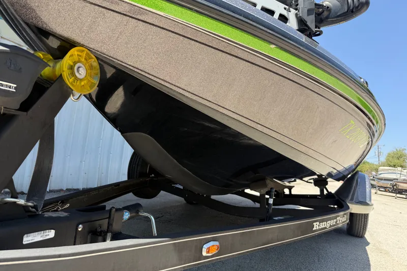 Slide: The Image of 2020 Ranger Z518 boat on trailer, close-up view of hull and trailer details. - 42