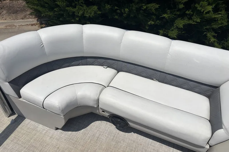Slide: The Image of Luxurious seating on 2020 Lund LX220 Pontoon boat, featuring plush white upholstery. - 6