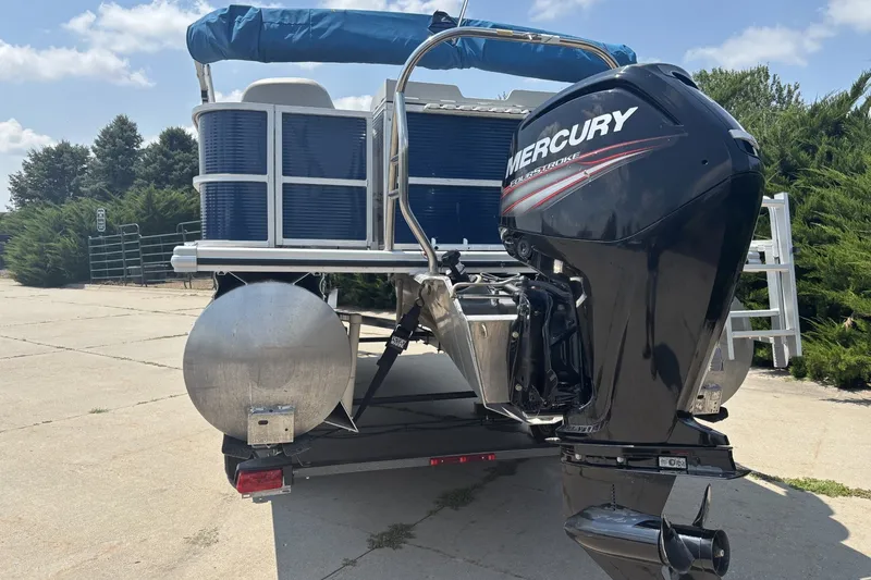 Slide: The Image of 2020 Lund LX220 Pontoon with Mercury outboard motor on a trailer. - 5