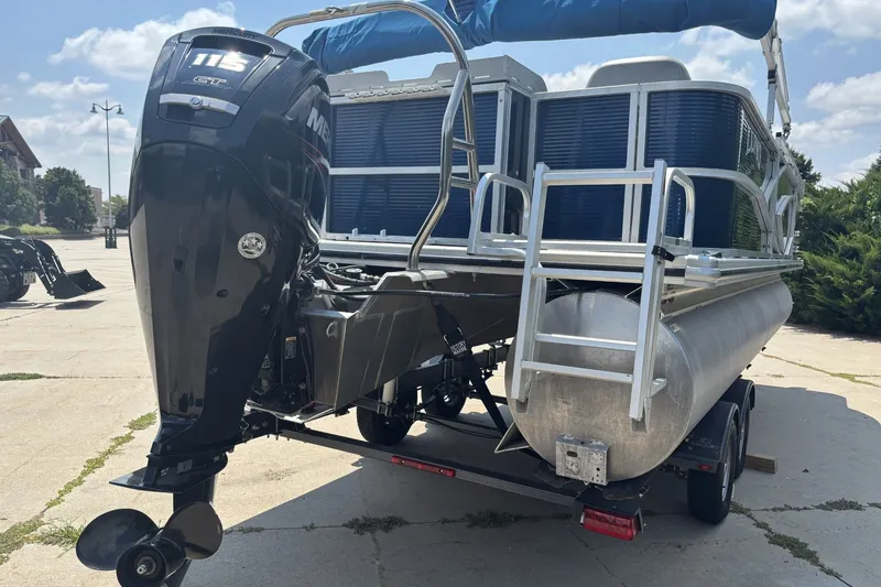 Slide: The Image of 2020 Lund LX220 Pontoon boat with powerful outboard motor on trailer. - 2