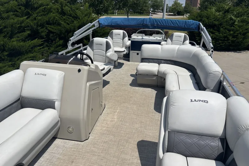 Slide: The Image of 2020 Lund LX220 Pontoon boat with spacious seating and modern design. - 8