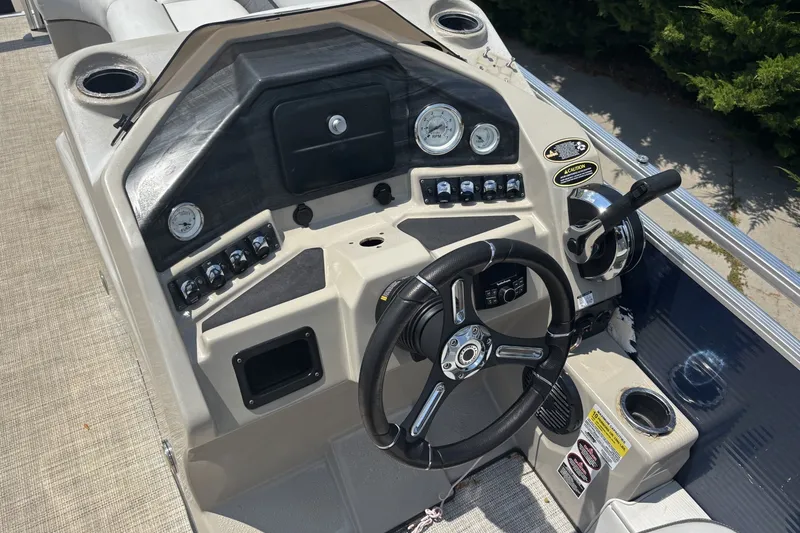 Slide: The Image of 2020 Lund LX220 Pontoon dashboard with steering wheel and control panel. - 1