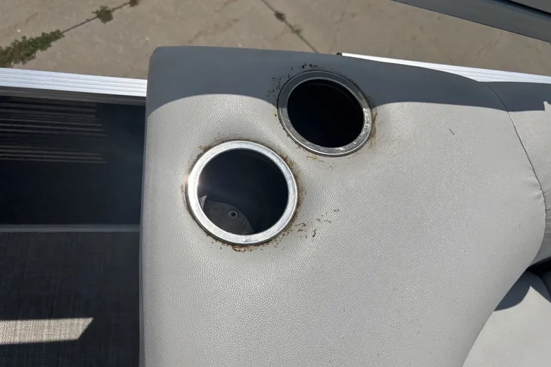 Slide: The Image of Cup holders on 2020 Lund LX220 Pontoon boat seat, showing wear and dirt. - 15