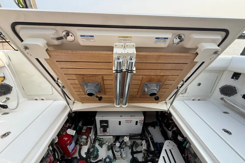 Slide: The Image of 2016 Boston Whaler 420 Outrage engine compartment with equipment and storage features. - 55