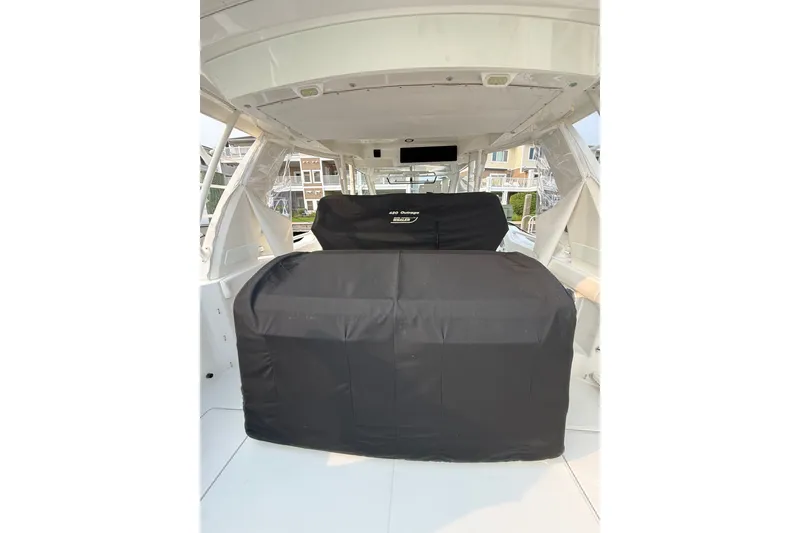 Slide: The Image of 2016 Boston Whaler 420 Outrage interior with covered seating area. - 54