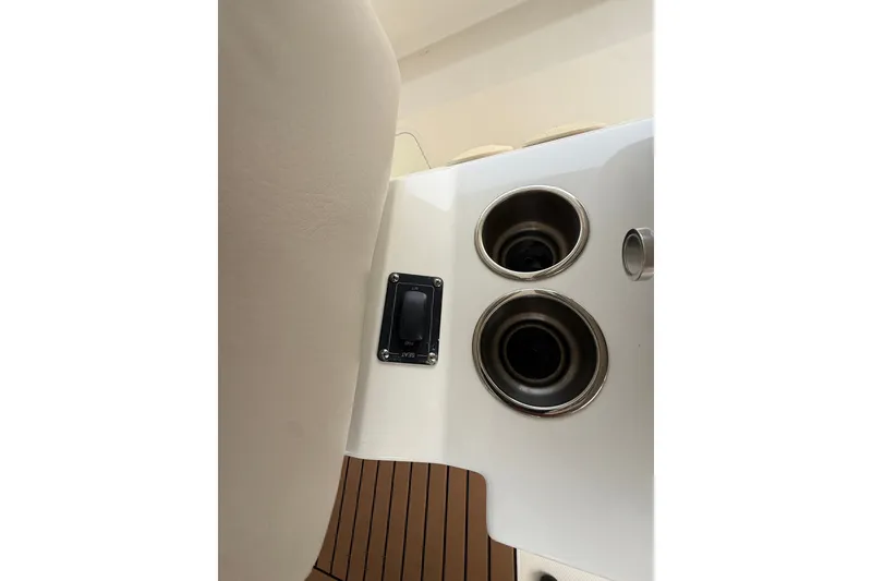 Slide: The Image of 2016 Boston Whaler 420 Outrage interior detail with cup holders and switch panel. - 24