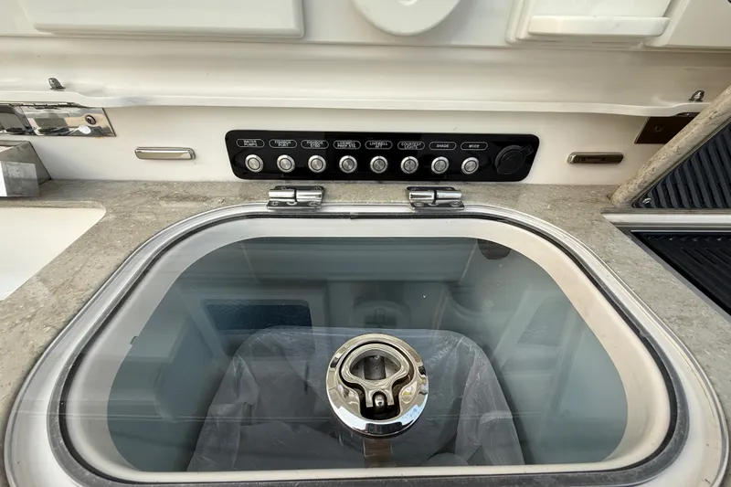 Slide: The Image of Control panel and compartment on a 2016 Boston Whaler 420 Outrage boat. - 31