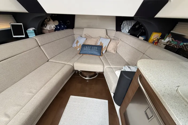 Slide: The Image of Luxurious interior of 2016 Boston Whaler 420 Outrage with beige seating and decorative pillows. - 40