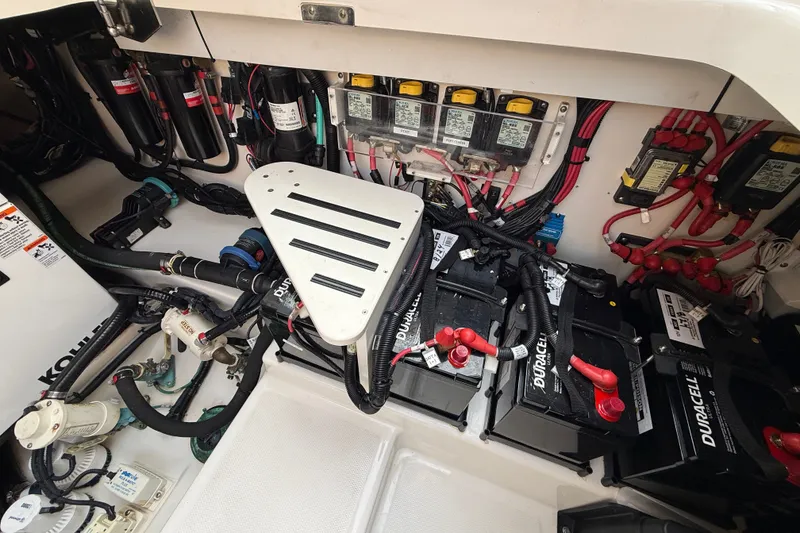 Slide: The Image of Engine compartment of a 2016 Boston Whaler 420 Outrage with batteries and wiring. - 58