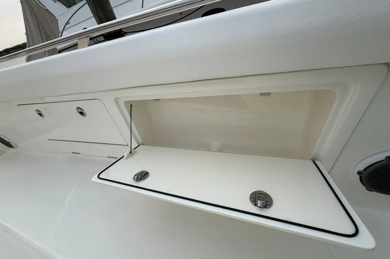 Slide: The Image of Open storage compartment on a 2016 Boston Whaler 420 Outrage boat deck. - 11