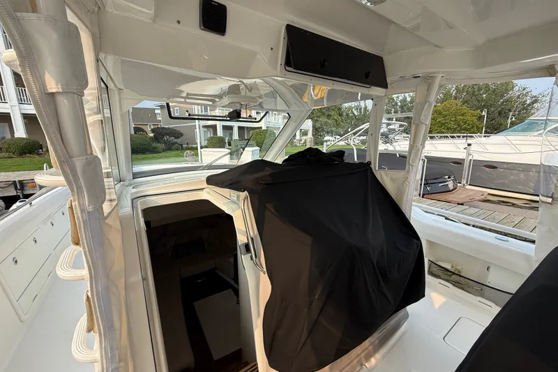 Slide: The Image of Interior view of a 2016 Boston Whaler 420 Outrage boat docked at a marina. - 52
