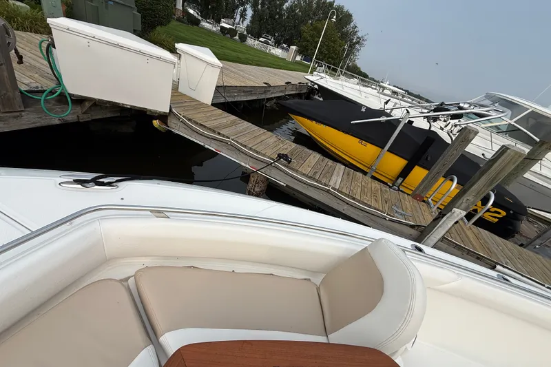 Slide: The Image of Boston Whaler 420 Outrage 2016 docked, with nearby boats and wooden pier. - 15