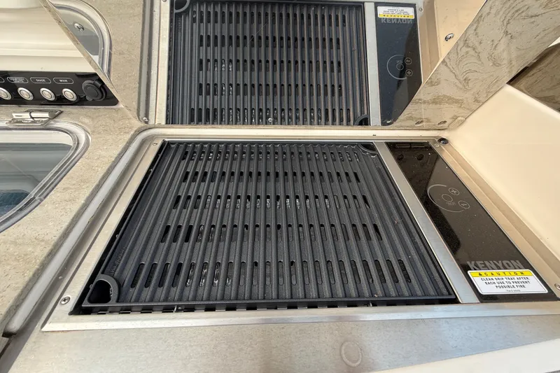 Slide: The Image of Built-in grill on 2016 Boston Whaler 420 Outrage boat, featuring Kenyon electric cooktop. - 30