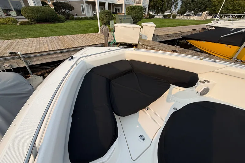 Slide: The Image of 2016 Boston Whaler 420 Outrage boat with cushioned seating at dockside. - 47