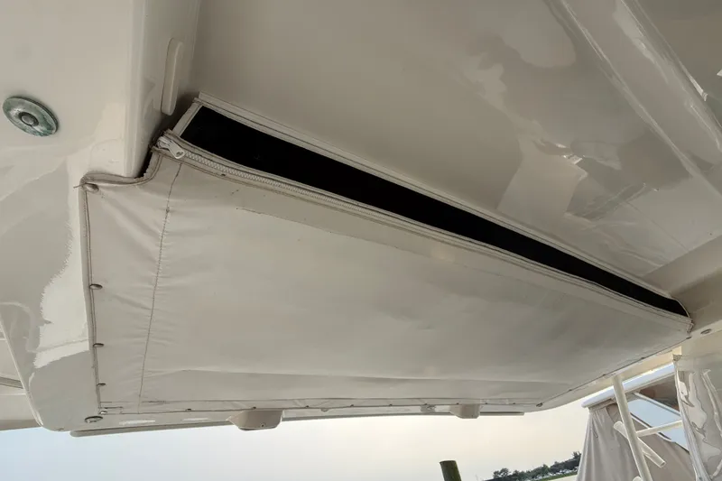 Slide: The Image of 2016 Boston Whaler 420 Outrage boat detail with white canvas cover and zipper. - 42