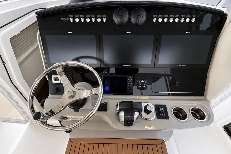 Slide: The Image of Control panel of 2016 Boston Whaler 420 Outrage with steering wheel and navigation screens. - 7