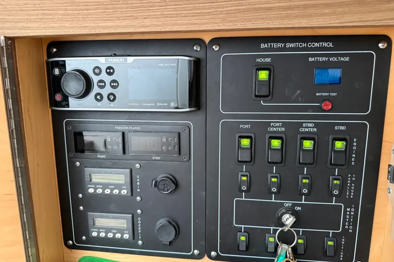 Slide: The Image of Control panel of a 2016 Boston Whaler 420 Outrage boat with audio and battery switches. - 34