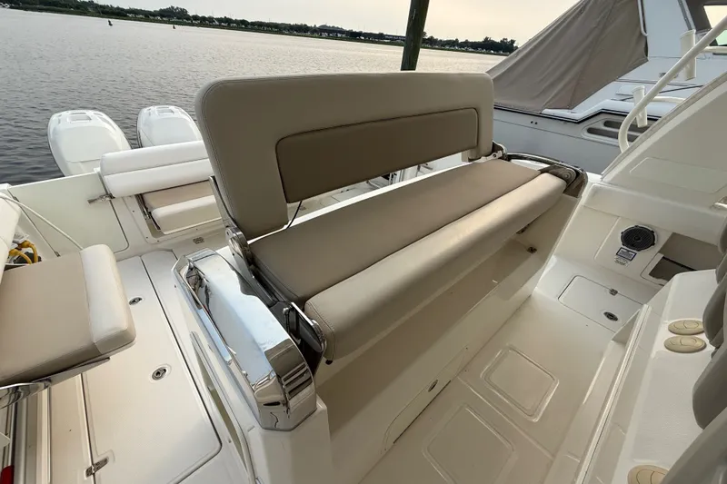 Slide: The Image of 2016 Boston Whaler 420 Outrage boat interior with seating and water view. - 29