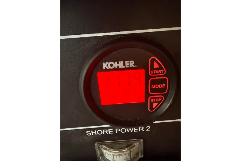 Slide: The Image of Kohler control panel on 2016 Boston Whaler 420 Outrage, displaying 117.4 volts. - 23