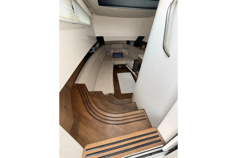 Slide: The Image of Interior of 2016 Boston Whaler 420 Outrage, featuring elegant seating and wooden flooring. - 41
