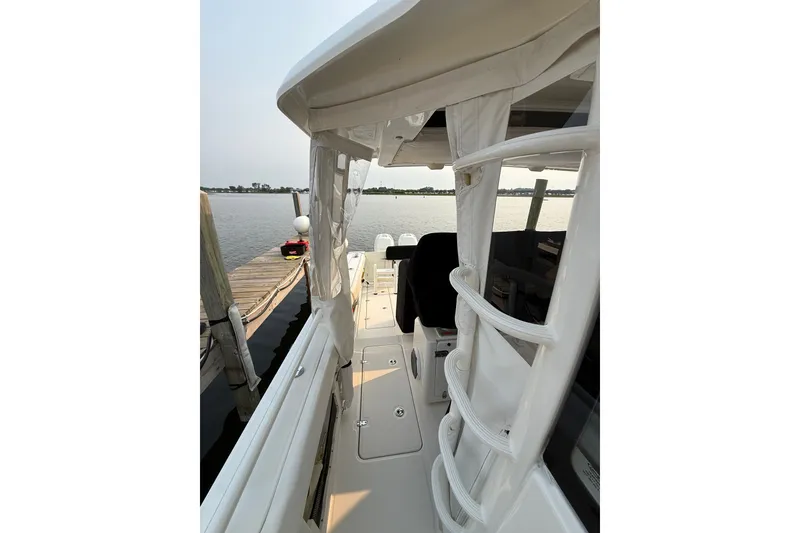 Slide: The Image of 2016 Boston Whaler 420 Outrage docked, showcasing sleek design and spacious deck. - 44