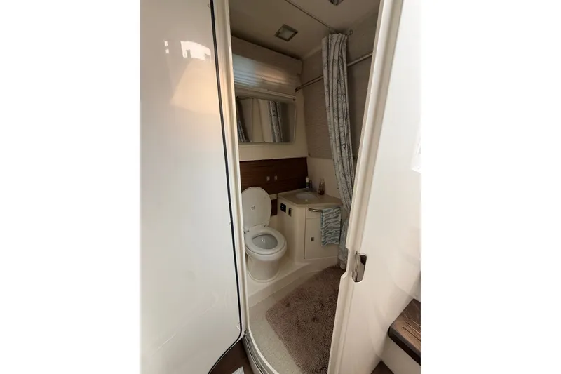 Slide: The Image of Bathroom interior of 2016 Boston Whaler 420 Outrage boat, featuring toilet and sink. - 36