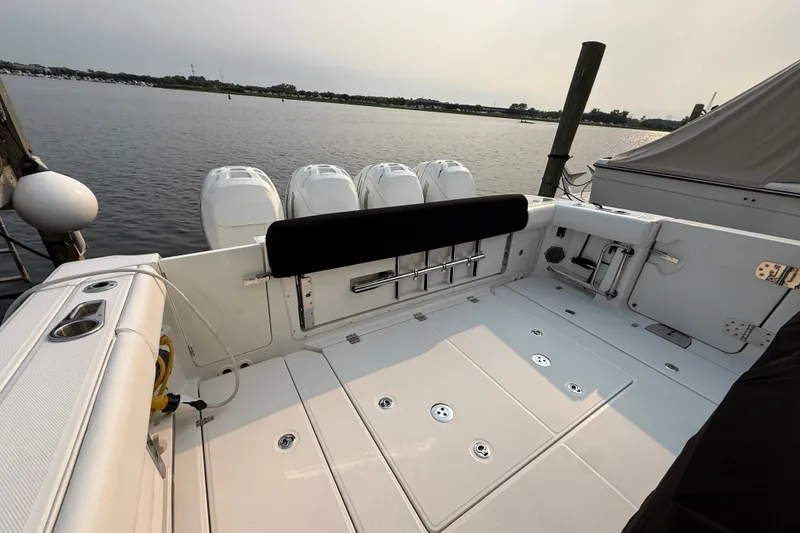 Slide: The Image of 2016 Boston Whaler 420 Outrage boat deck with quad engines, docked by the water. - 43