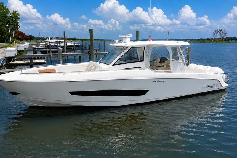 The Image of 2016 Boston Whaler 420 Outrage boat docked on a sunny day with blue skies. - 0