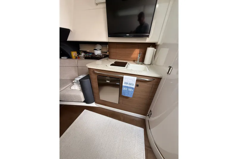Slide: The Image of 2016 Boston Whaler 420 Outrage interior with kitchenette and modern amenities. - 35