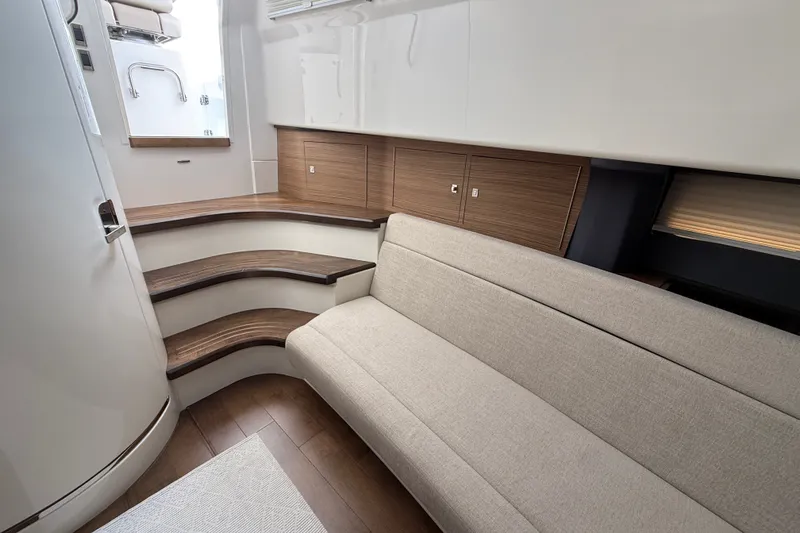 Slide: The Image of Interior of 2016 Boston Whaler 420 Outrage, featuring elegant seating and wooden cabinetry. - 38