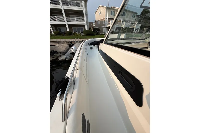 Slide: The Image of 2016 Boston Whaler 420 Outrage boat docked near waterfront homes. - 49