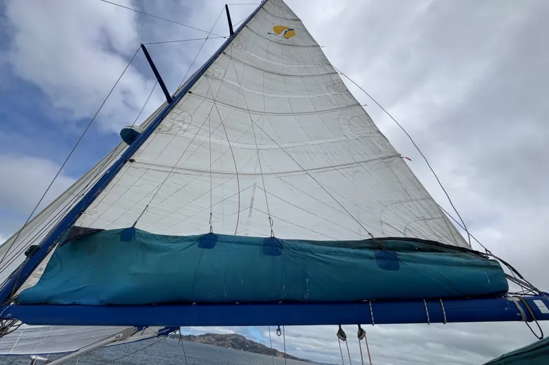 Slide: The Image of Sailing yacht St Francis 44, 2000 model, with sails unfurled against a cloudy sky. - 61