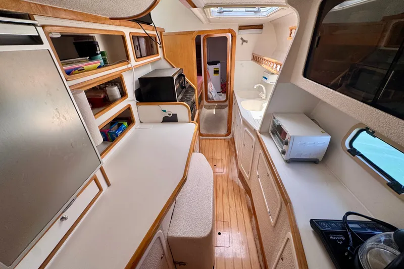 Slide: The Image of Interior of 2000 St Francis 44 yacht kitchen with wooden cabinetry and modern appliances. - 23