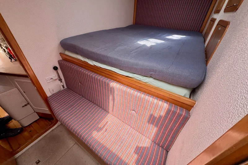 Slide: The Image of Cozy cabin interior of 2000 St Francis 44 yacht with striped seating and bed. - 34